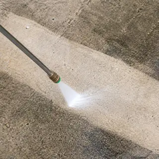 Pressure washer cleaning a concrete step