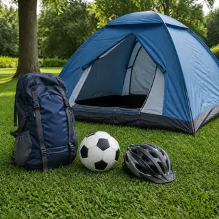 Tent, backpack and soccer ball on grass