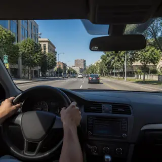 View through a car windshield onto a city street